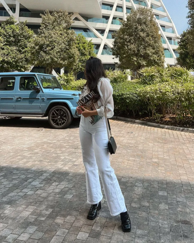 White Jeans Outfit Ideas for a Stylish Look 14 JEANS AND BLACK BOOTS